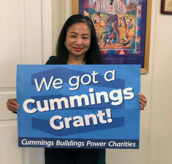Executive Director holding the cummings sign 